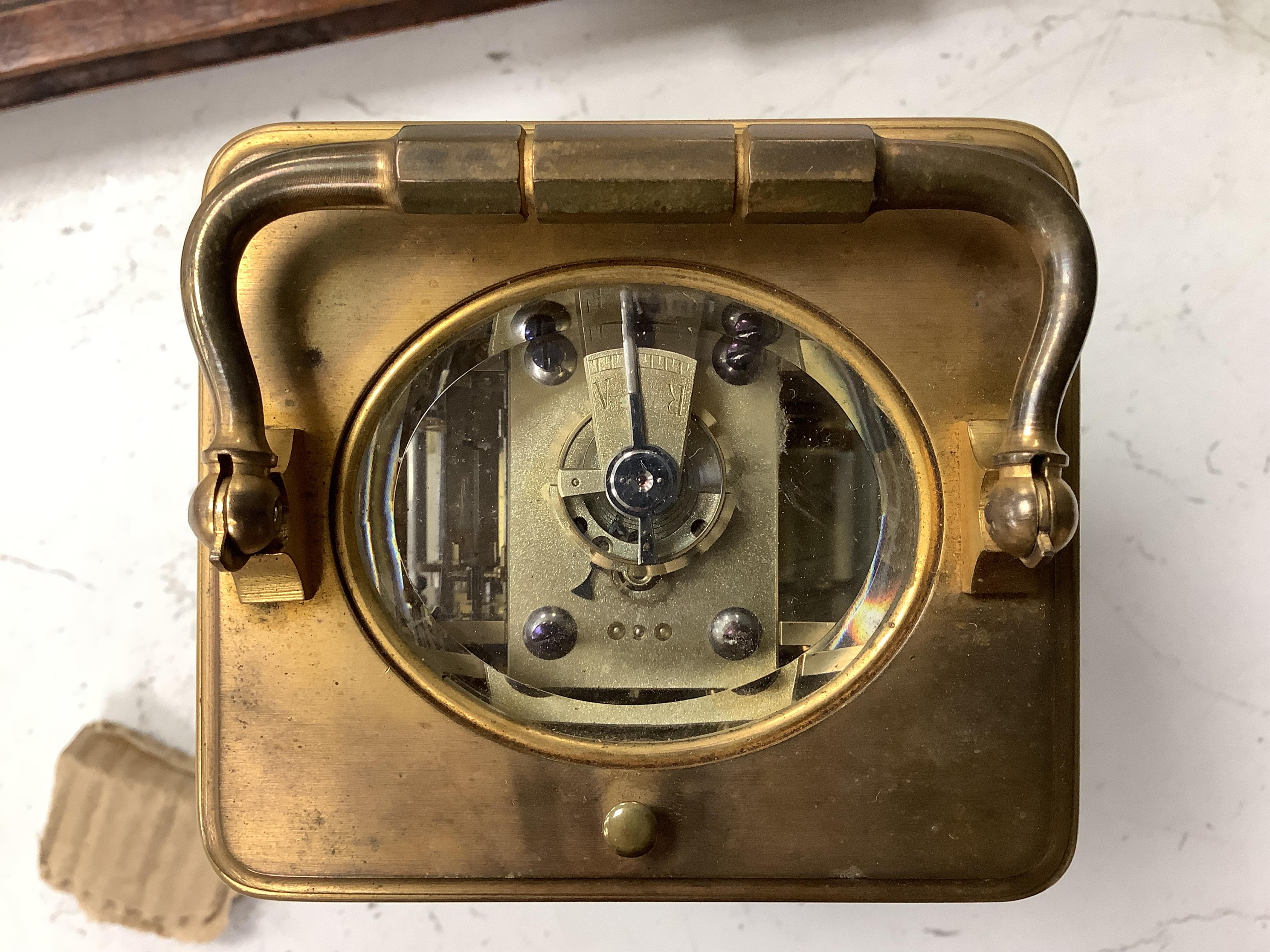 A late 19th century lacquered brass repeating carriage clock, by Henri Jacot and an Edwardian inlaid mantel timepiece with key, largest 23cm high